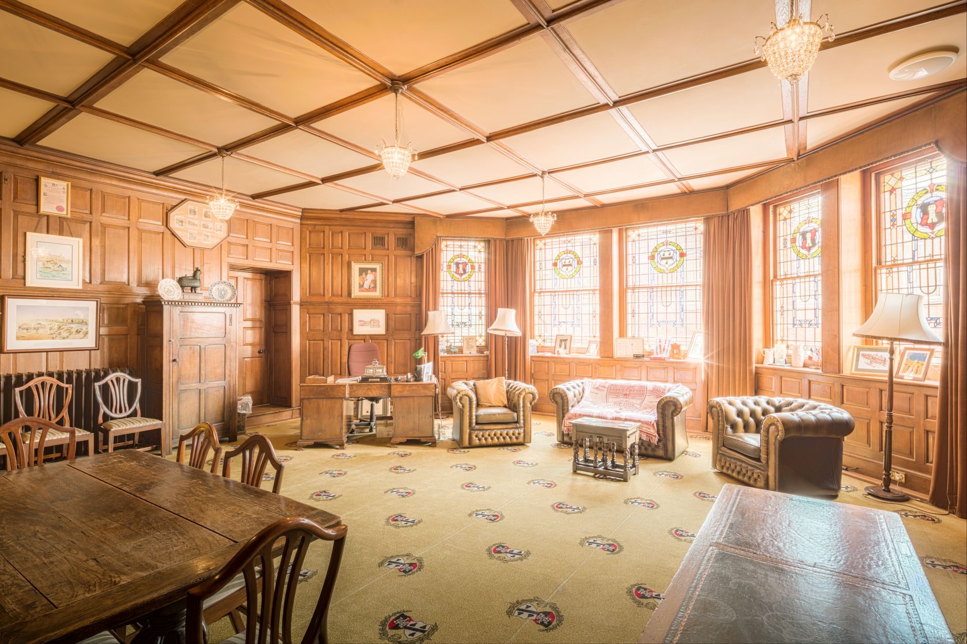 Elegant vintage interior of Worcester Guildhall with stained glass and wooden furnishings.