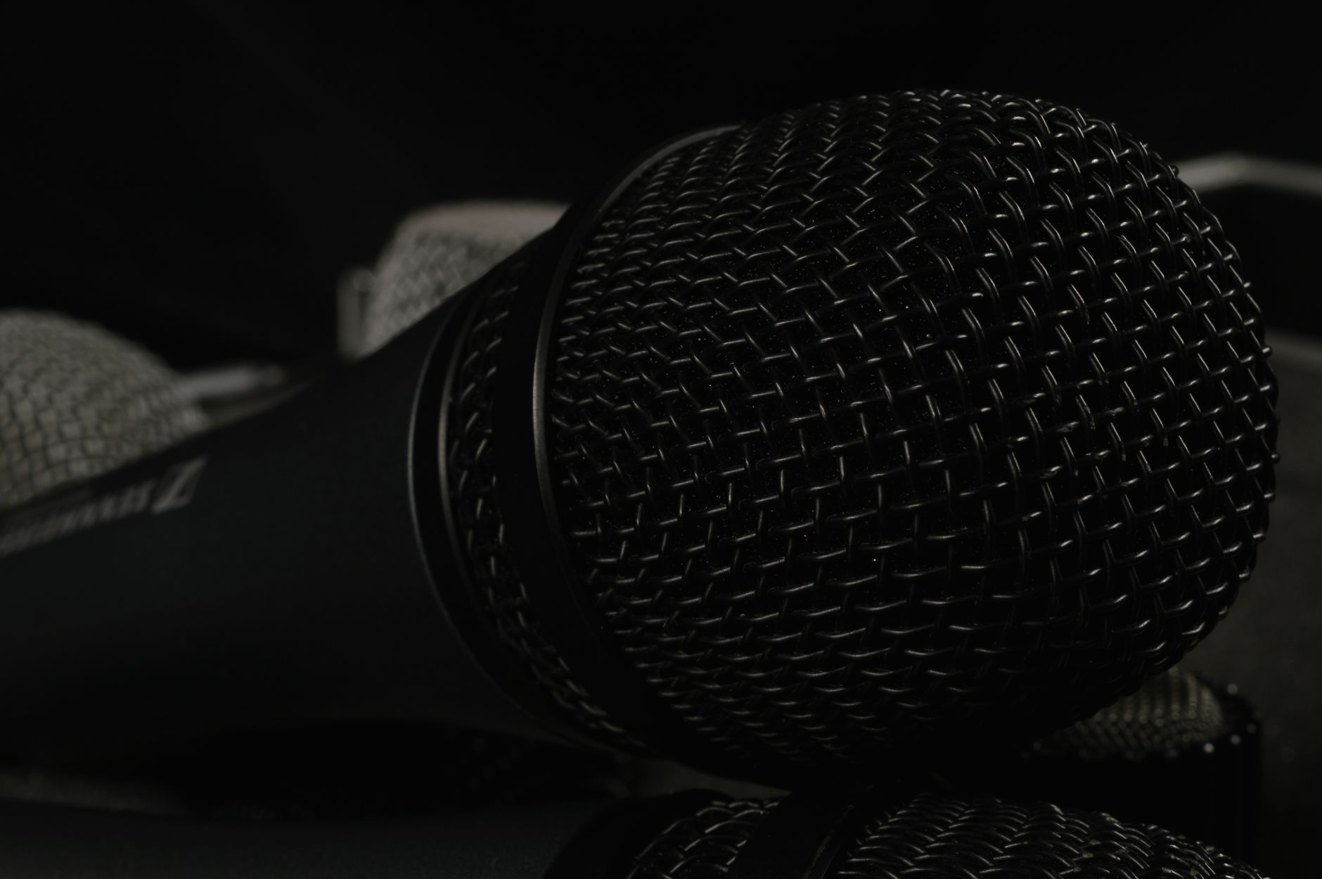 A detailed close-up of professional microphones featuring windscreens, ideal for tech and audio themes.
